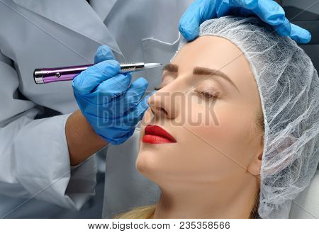 Microblading. Cosmetologist Making Permanent Makeup. Attractive Woman Getting Facial Care And Tattoo