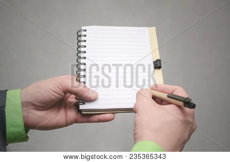 Businessman Holds In Hand A Note Pad With Pen. To Do List Template. Goals Or Business Tricks. Busine