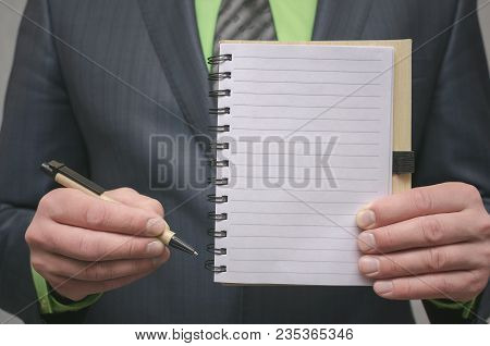 Businessman Holds In Hand A Note Pad With Pen. To Do List Template. Goals Or Business Tricks. Busine