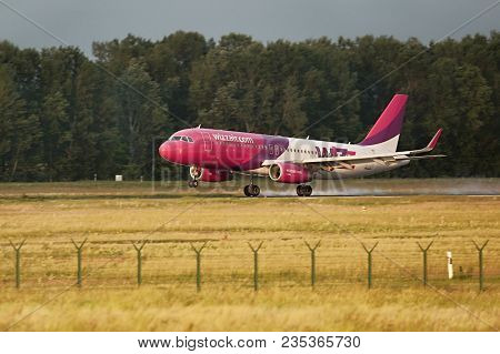 BUDAPEST, HUNGARY - MAY 5, 2014: Wizzair A320 landing at Budapest Liszt Ferenc Airport. Budapest is one of Wizzair's most important bases.