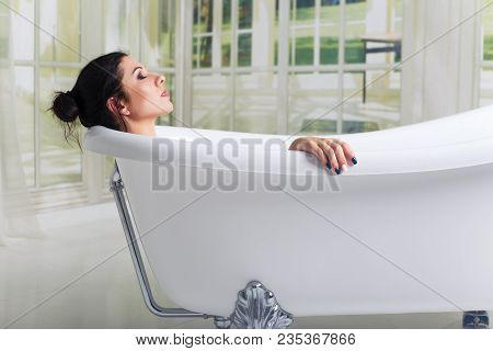 Bathing Woman Relaxing In Bath Smiling Relaxing With Eyes Closed.