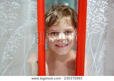Happy Little Kid Boy In The Shower Cabin Wet And Smiling. Adorable Child With Blond Hairs Taking Bat