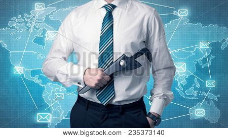 Businessman holding tool with global map graphic on the background
