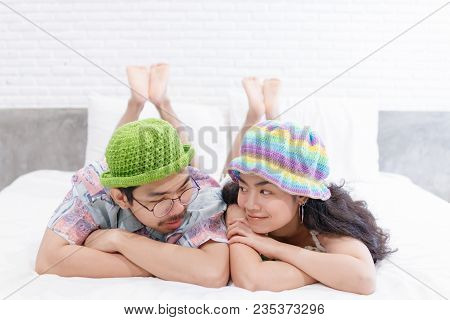 Couple Asian Man And Woman With Woolhat Together Funny Moment On White Bed