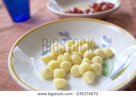 Dish Of Potato Small Dumplings With Pieces Of Fresh Tomatoes