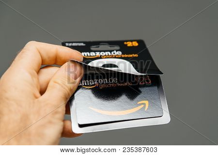 Paris, France - Apr 1, 2018: Man Opening 25 Euros Amazon Gift Card Issued By Amazon Germany, Valid I