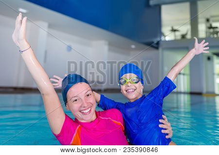 Swimming School. Cute Little Boy Having Fun With Swimming Instructor