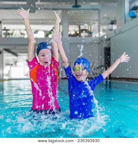 Swimming School. Cute Little Boy Having Fun With Swimming Instructor
