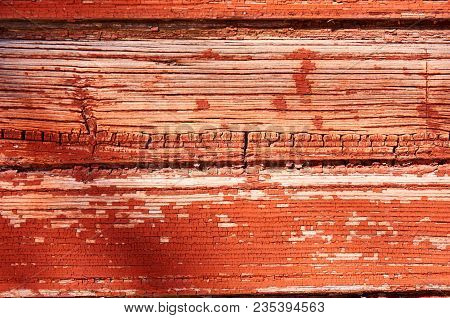 Old Wooden Background Painted With Red Paint With A Texture Of Cracks And Scratches. Red Background