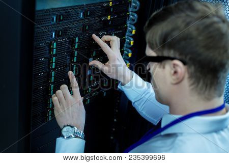Serious Work. Experienced Concentrated Operator Working And Pressing Black Buttons