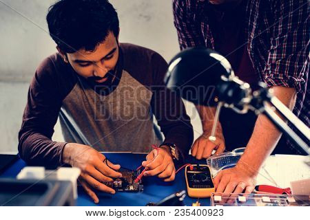Group of people working at eletronic repair shop