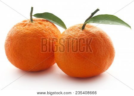 Fresh Orange With Green Leaf Over White Background