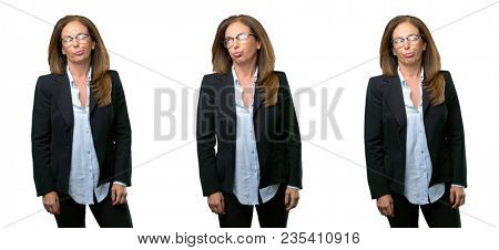 Middle age business woman making funny face fooling over white background