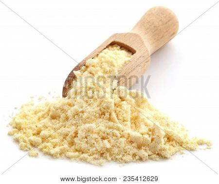 Gram Flour In A Wooden Scoop Over White Background