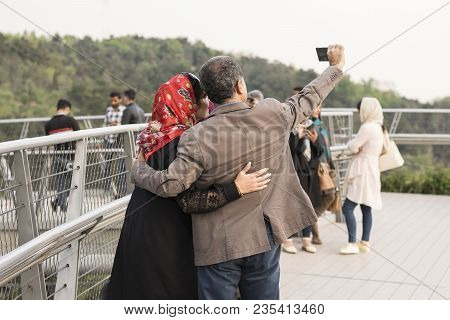 Tehran, Iran - April 9, 2018 Group Fo Family Taking Selfi At Ab-o-atash Park ( Tabiat Bridge)
