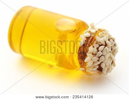 Peeled Sesame Seeds With Oil In A Small Jar Over White Background