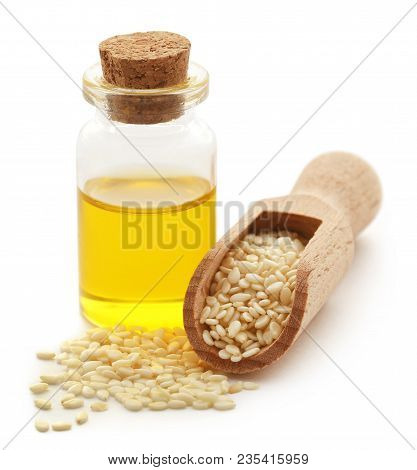 Peeled Sesame Seeds With Oil In A Small Jar Over White Background
