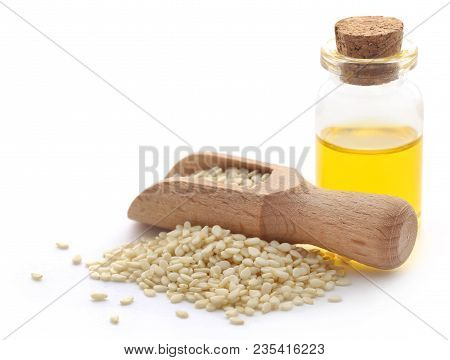 Peeled Sesame Seeds With Oil In A Jar Over White