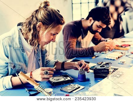 Group of people working at eletronic repair shop