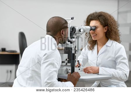 Photo Of Patient Looking At Apparatus During Vision Checking With Oculist.