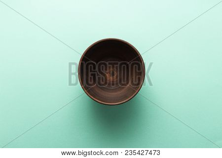 Empty Brown Plate On Pastel Green Background, Top View, Flat Lay