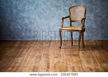 Old Chair On A Gray Wall Background