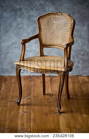 Old Chair On A Gray Wall Background