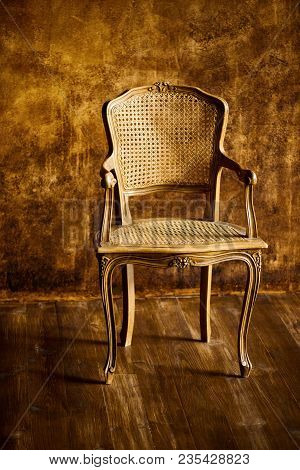 Old Chair On A Brown Wall Background