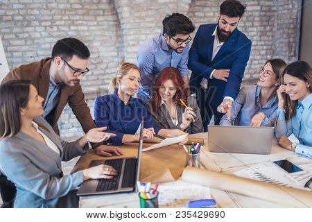 Business, Technology And Office Concept - Business Team On Meeting In Modernoffice Interior And Work