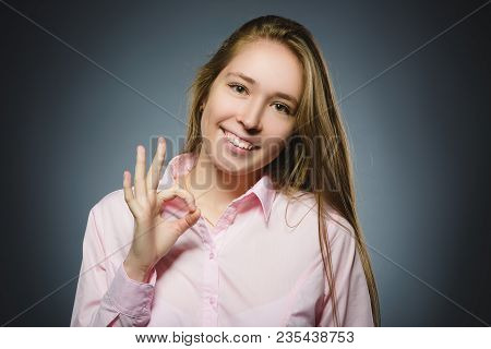 Closeup Portrait Of Handsome Teen Show Ok Isolate On Grey Background.