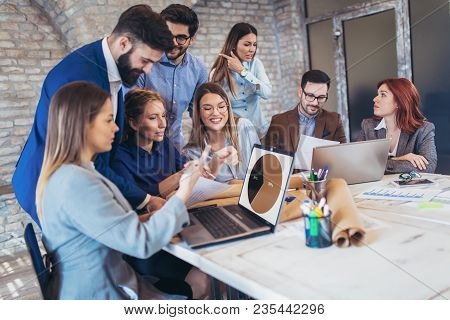 Business, Technology And Office Concept - Business Team On Meeting In Modernoffice Interior And Work