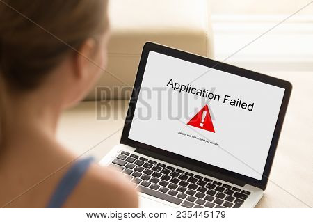 Girl Looking At Laptop With Application Failed Error On Screen. Software Failure, App Stopped Workin