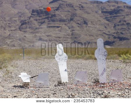 Pellets Flying After The Middle Silhouette Is Struck By A Shotgun With A Clay Bird In The Air
