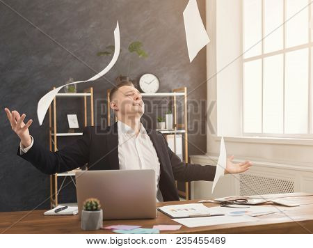 Happy Successful Businessman Win, Celebrate In Office, Sitting At Workplace And Throwing Up Papers, 
