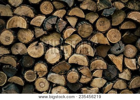 Firewood In Woodpile, Prepared For Winter. Pile Of Firewood. The Firewood Background. A Stack Of Nea