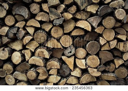 Firewood In Woodpile, Prepared For Winter. Pile Of Firewood. The Firewood Background. A Stack Of Nea
