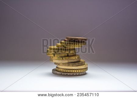 Euro Coins Stacked On Each Other In Different Positions.