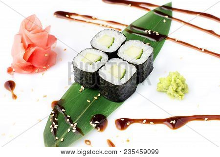 Delicious Fresh Mini-rolls With Cucumber On A Banana Leaf. Sushi Rolls On A White Background With Gi