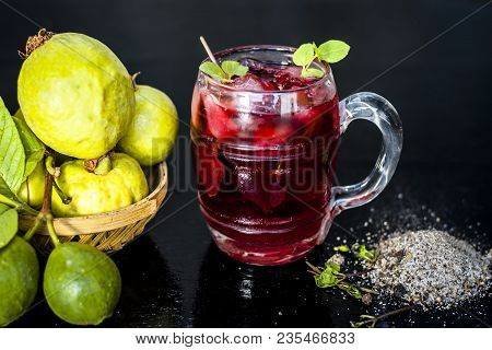Close Up Of Popular Indian Shrabat Of Guava With Sugar And Masala In A Glass With Raw Fresh Guava On