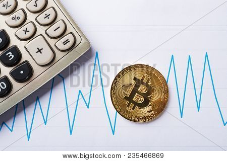 Bitcoins And Caculator On A Chart As Financial Concept