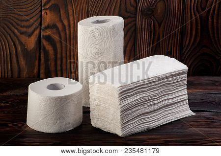 Toilet Tissue Paper On Wooden Board Background