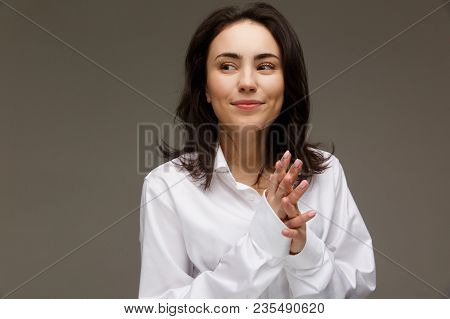 Beautiful Girl In A White Shirt Shows Emotions. On A Light Background.