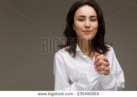 Beautiful Girl In A White Shirt Shows Emotions. On A Light Background.