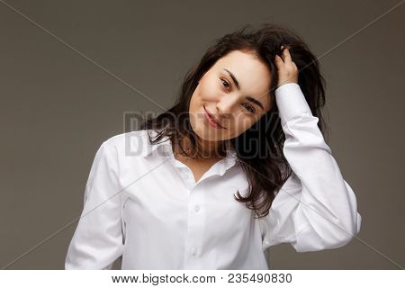 Beautiful Girl In A White Shirt Shows Emotions - Smile, Fun. On A Light Background.