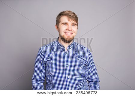 Portrait Of A Handsome Young Man Smiling Against Blue Background