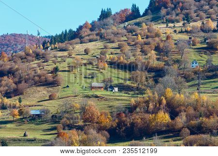 Autumn Carpathian Mountains Landscape With Multicolored Trees And Mountain Village Outskirts On Slop