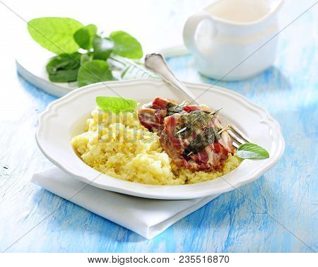 Pan Fried Veal Cutlets Saltimbocca Served With Saffron Risotto.