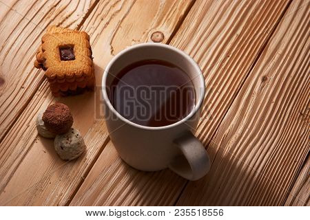 Cup Of Tea With Tasty Cookies On Wooden Background
