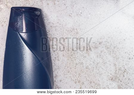 Blue Shampoo On Foam Background Top View