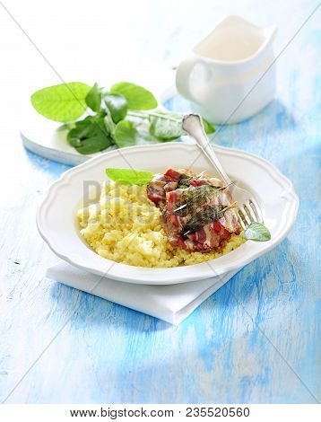 Pan Fried Veal Cutlets Saltimbocca Served With Saffron Risotto.